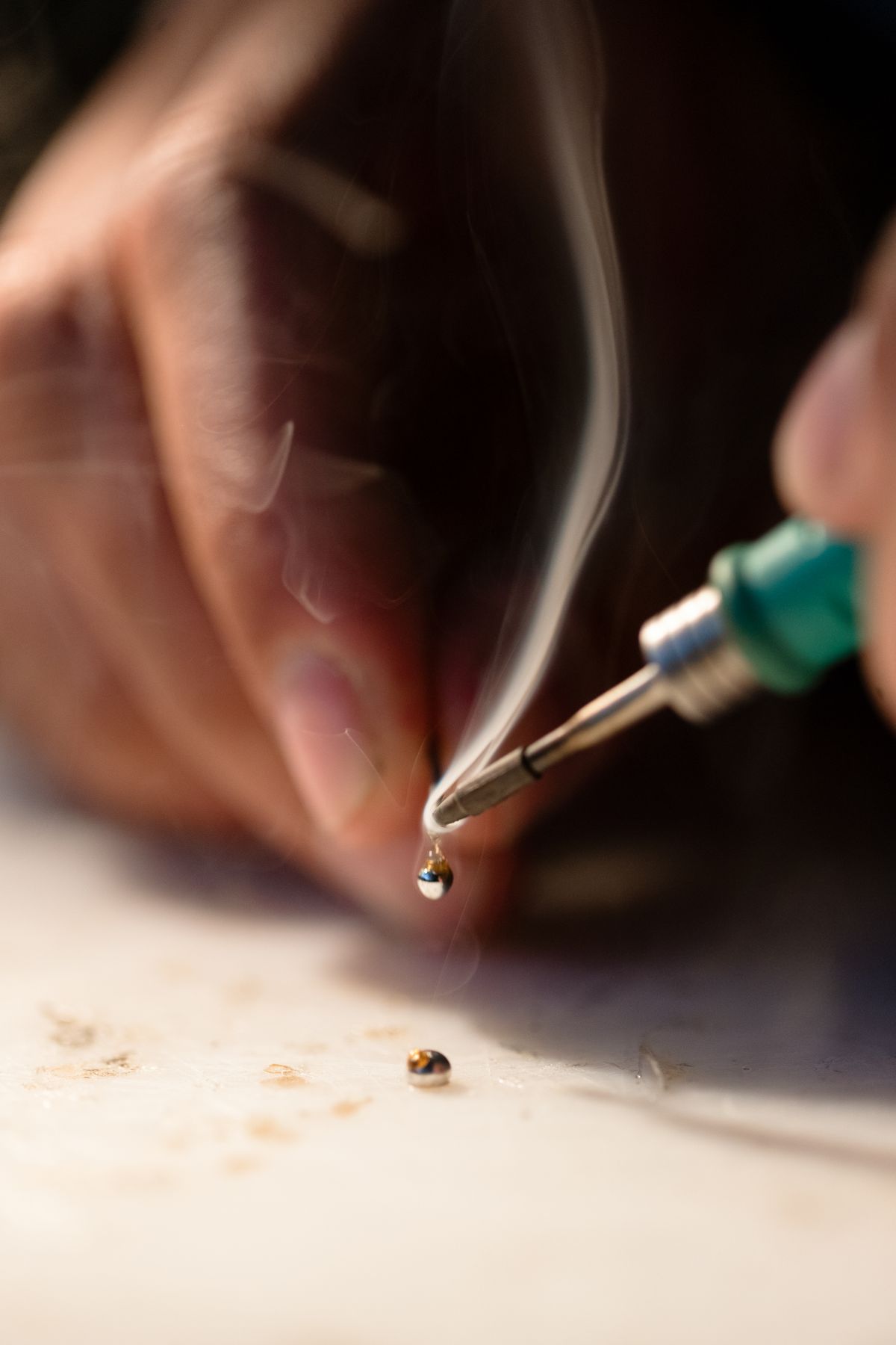 Engineer soldering a circuit board in a lab