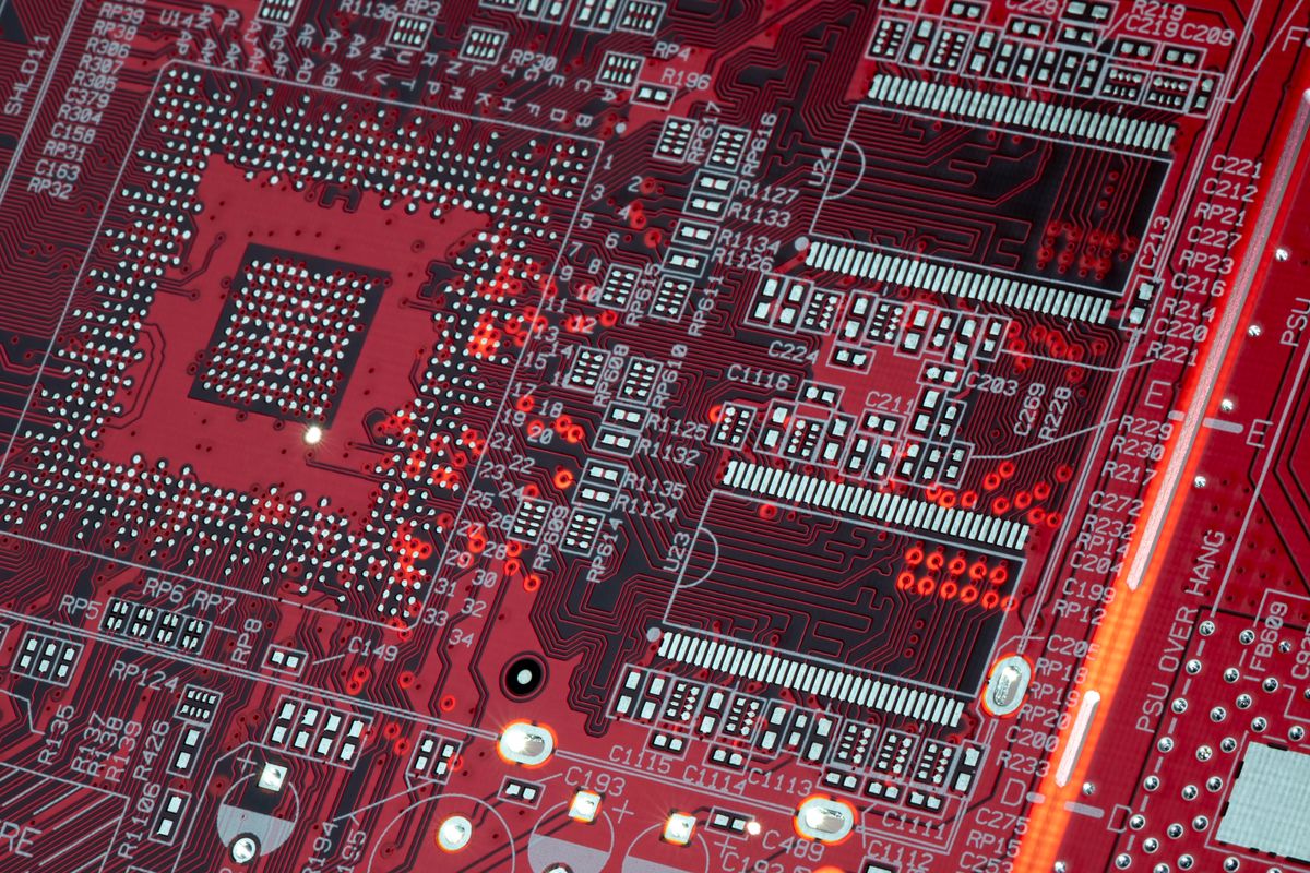 Close-up of a red circuit board with electronic components